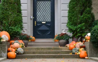 Fall pumpkins and flowers on front steps