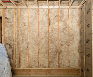 Installing batt insulation for a new home build.
