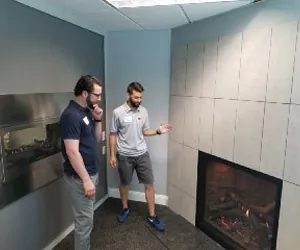 Two men discussing fireplaces.