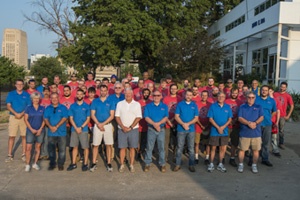 Large group photo of the Hayes Company team standing outside on a sunny day.