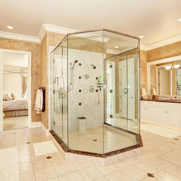 Framed hinged glass shower doors in a large bathroom.