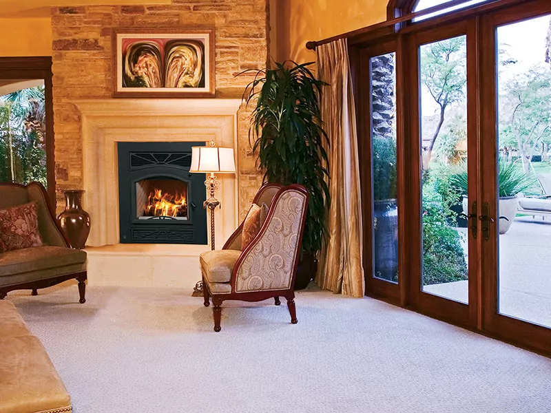 Wood fireplace in a room with patio access