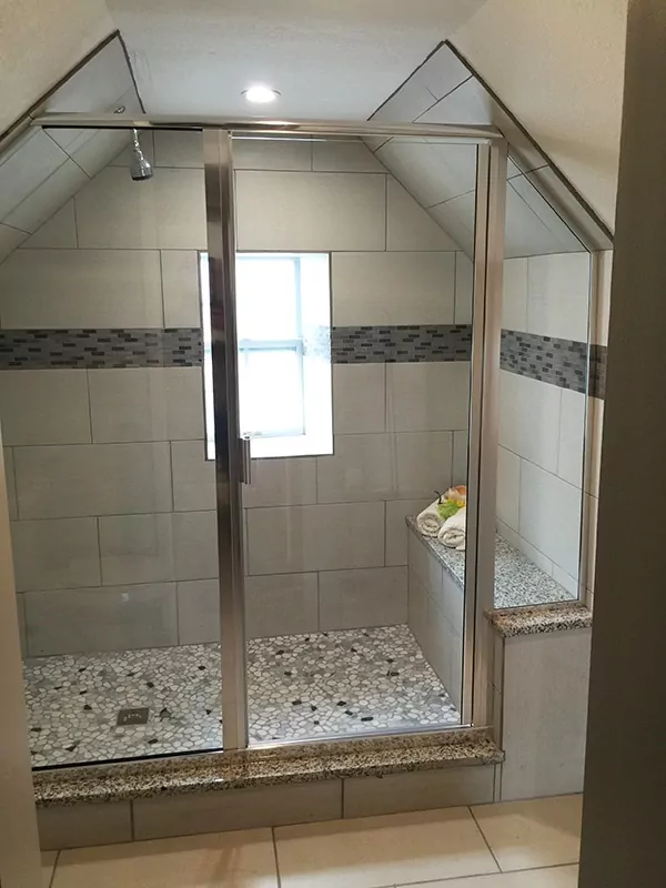 Partial ceiling tiled shower with new shower doors.
