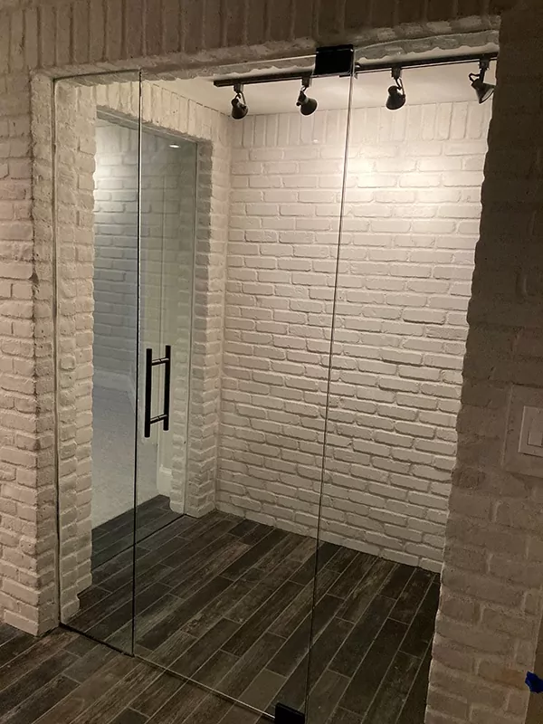 Glass doors and wall for a brick wine room