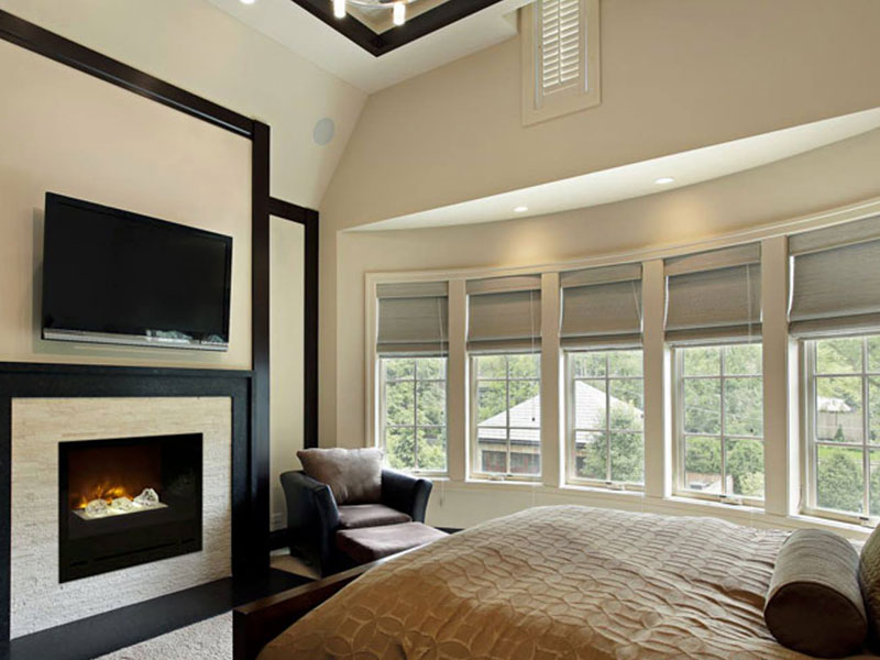 Electric fireplace in white bedroom.