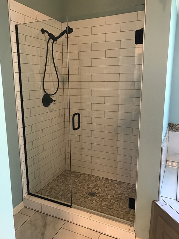 New hinged shower door in bathroom