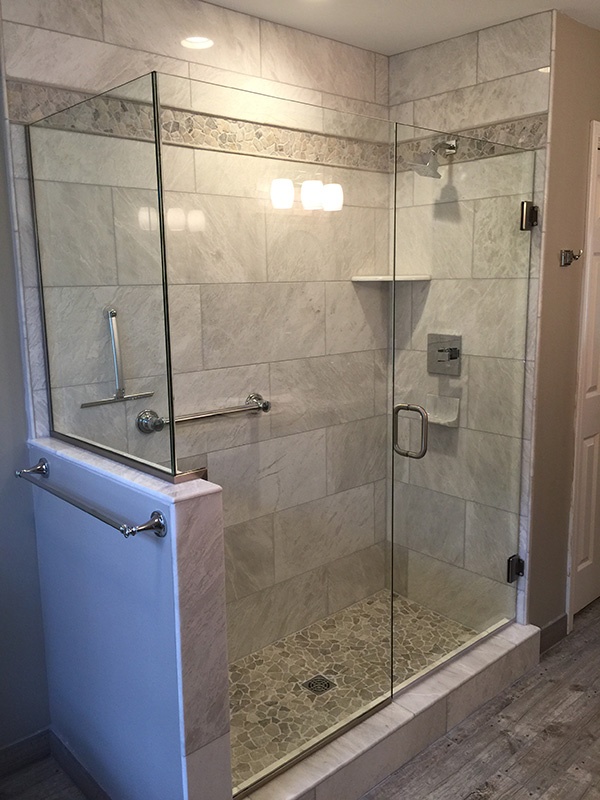 New shower in bathroom with side towel rack.