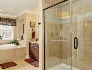 Glass shower door in a large bathroom.
