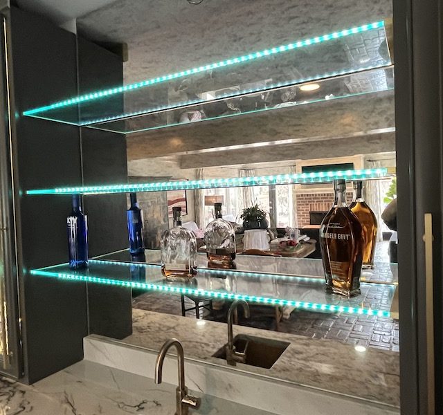 Custom bar mirror and shelves. Shelves include a blue light going through the glass.