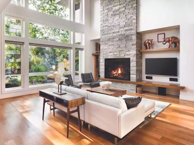 American Hearth Line direct vent gas fireplace with brick chimney, in home's daytime setting.