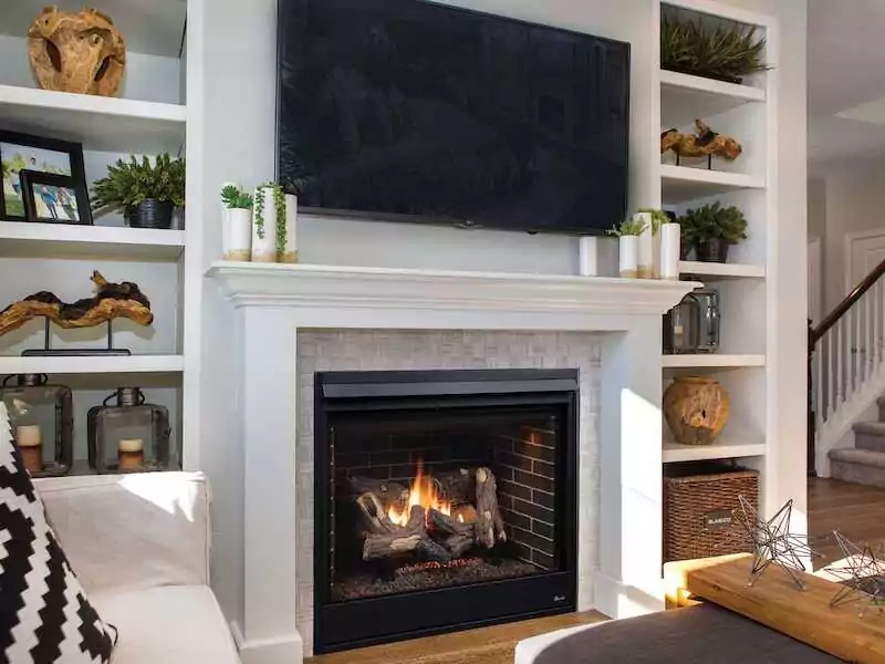 Superior indoor gas fireplace in a homes white living room.
