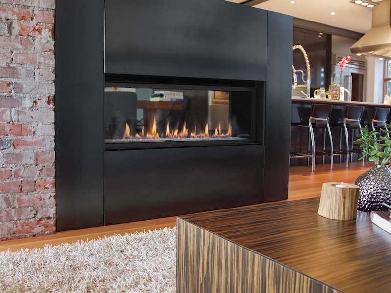 Superior indoor, see-through gas fireplace, embedded inside a modern homes wall.