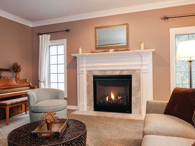 Superior Indoor Gas Fireplace, complimented by marble and white mantel.