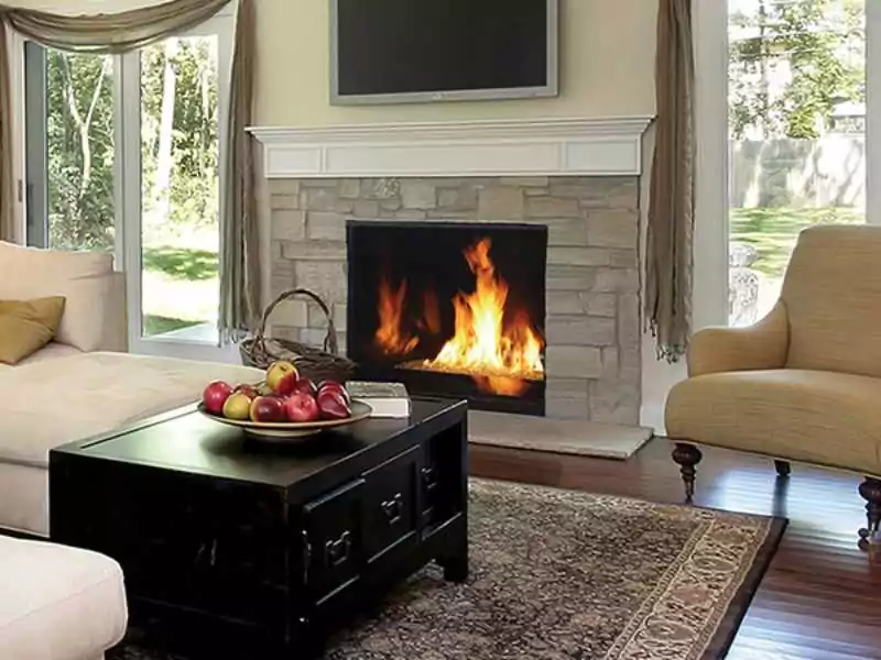 Wood burning fireplace inside a sophisticated homes living room.