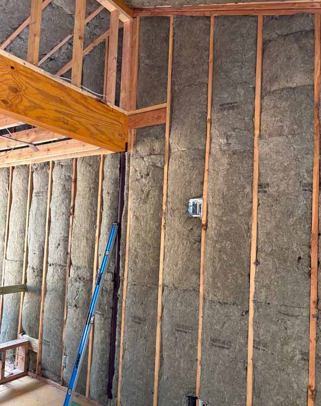 Wall cavities filled with Rockwool ComfortBatt mineral wool insulation in a new construction home for energy efficiency and soundproofing.