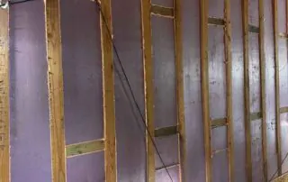 1.5-inch rigid foamboard insulation installed between wood-framed wall studs with fiberglass batt ceiling insulation at 74 Broadway, Kansas City 1.5-inch rigid foamboard insulation installed between wood-framed wall studs with fiberglass batt ceiling insulation at 74 Broadway, Kansas City.