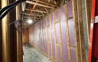 1.5-inch rigid foamboard insulation on framed exterior walls of a commercial building showing mechanical, plumbing, and electrical rough-in at 74 Broadway Kansas City. 1.5-inch rigid foamboard insulation on framed exterior walls of a commercial building showing mechanical, plumbing, and electrical rough-in at 74 Broadway Kansas City.