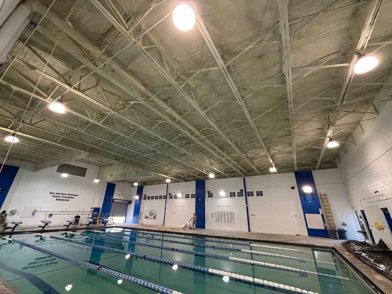 Rockhurst High School natatorium pool with fully insulated and painted ceiling after project completion.