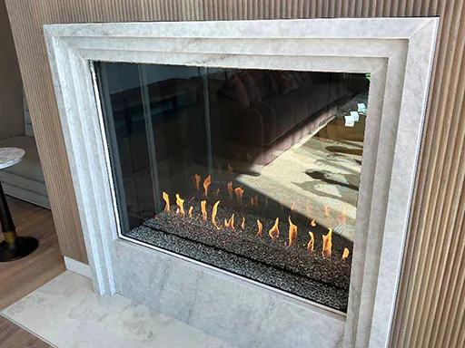 Hayes Company Montigo Prodigy II gas fireplace with stone surround at Berkley Riverfront in Kansas City, MO.