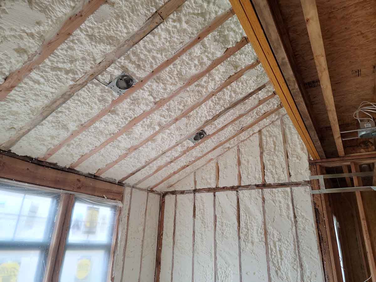 Hayes Insulation KC open-cell spray foam insulation applied to the vaulted ceiling rafters and exterior wall studs of a renovation in Kansas City, MO.